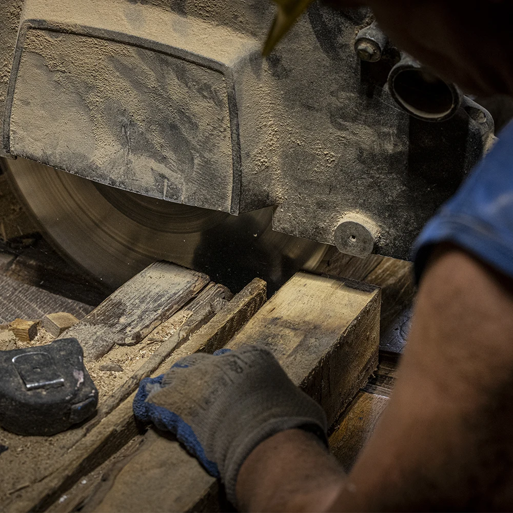 Closeup of cutting wood with a miter saw